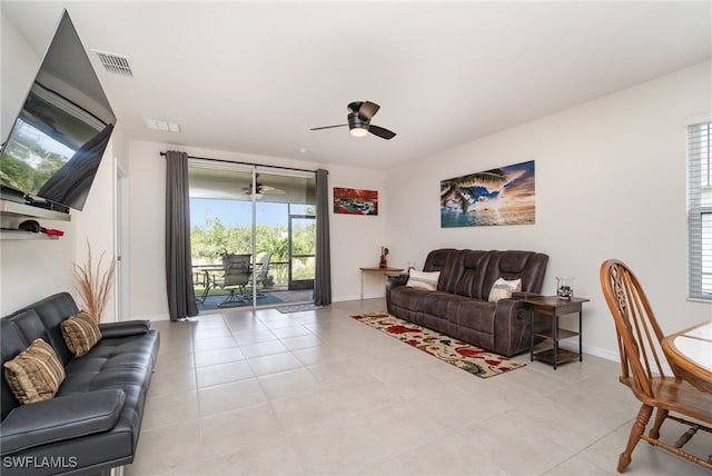 tiled living room featuring ceiling fan