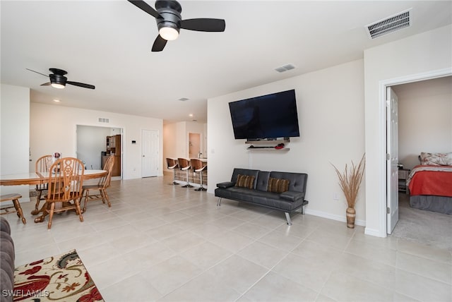 tiled living room with ceiling fan