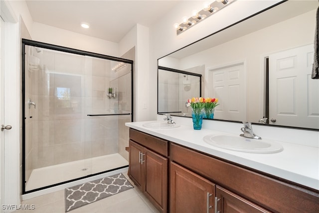 bathroom featuring tile patterned flooring, vanity, and an enclosed shower