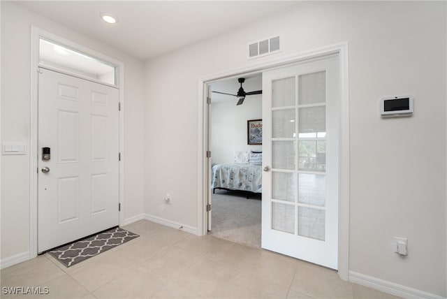 tiled entryway with ceiling fan