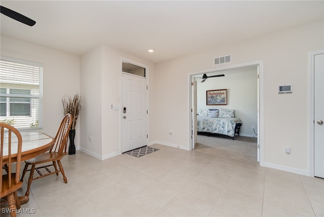 tiled foyer featuring ceiling fan