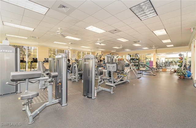 workout area featuring a paneled ceiling and ceiling fan