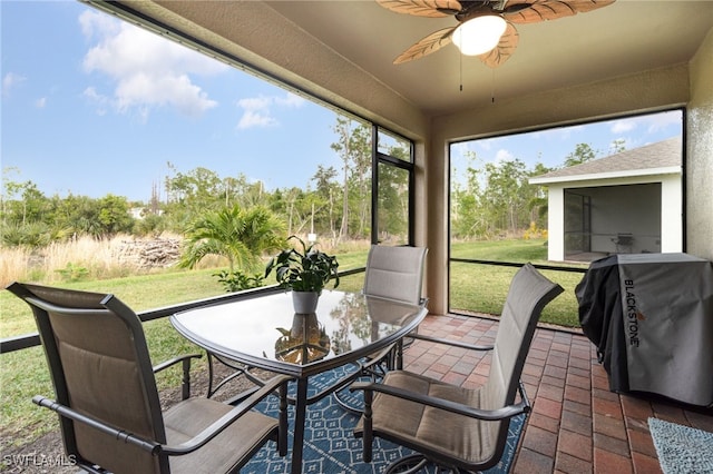 sunroom / solarium featuring ceiling fan