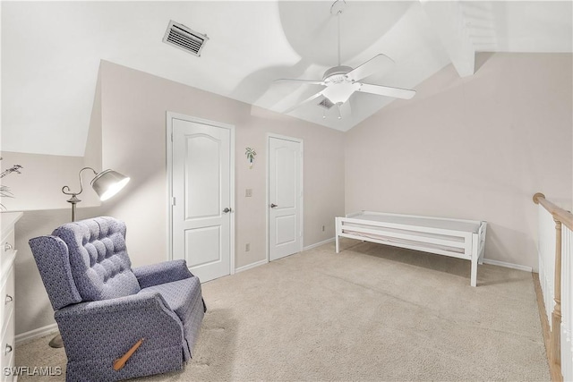 sitting room with lofted ceiling with beams, carpet flooring, visible vents, baseboards, and a ceiling fan