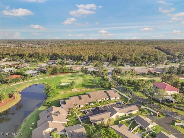 drone / aerial view with a residential view, view of golf course, and a water view