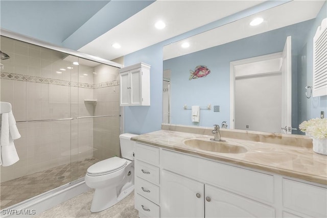 bathroom featuring tile patterned flooring, toilet, recessed lighting, vanity, and a stall shower