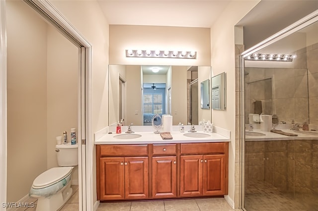 bathroom featuring walk in shower, tile patterned flooring, vanity, and toilet