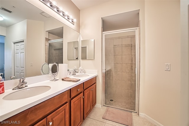 bathroom featuring tile patterned flooring, vanity, and an enclosed shower