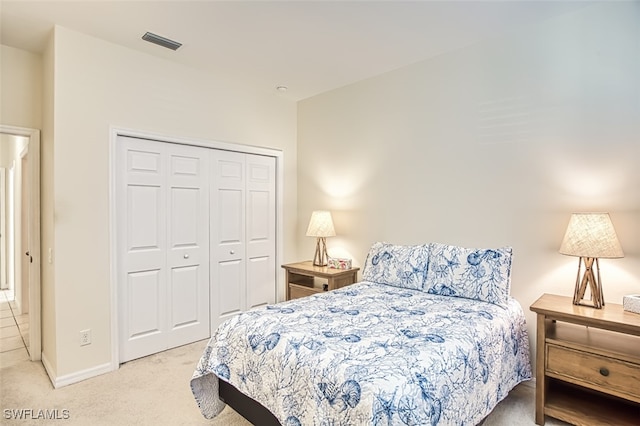 bedroom with light colored carpet and a closet