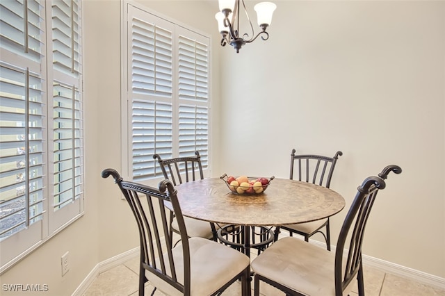 tiled dining space with a chandelier