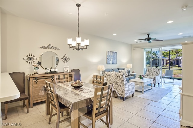 tiled dining area with ceiling fan with notable chandelier