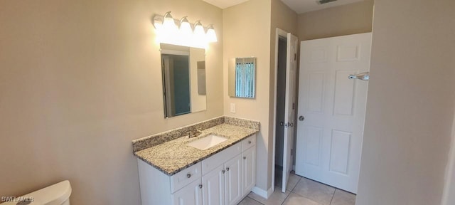 bathroom featuring tile patterned floors, vanity, and toilet