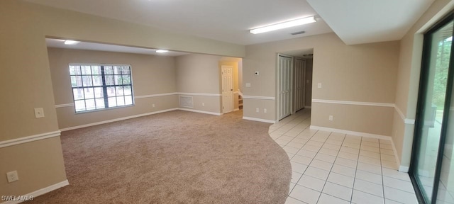 spare room featuring light colored carpet