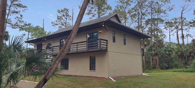 880 Wilson Blvd N, Naples, FL 34120 - view of property exterior with stucco siding, a lawn, and a balcony