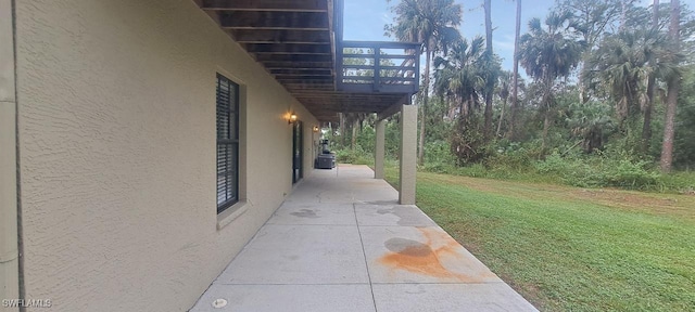 view of home's exterior featuring a lawn and a deck