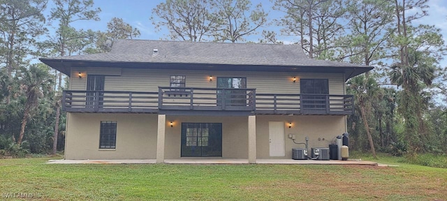 back of house with a lawn, a patio area, a balcony, and central AC