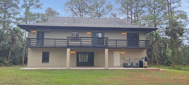 880 Wilson Blvd N, Naples, FL 34120 - back of house with a patio, a yard, a balcony, stucco siding, and a shingled roof
