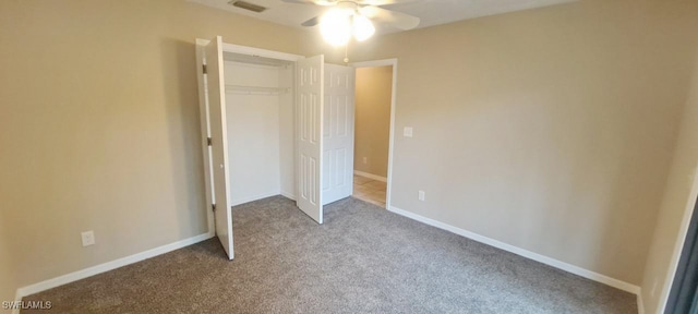 unfurnished bedroom with ceiling fan, a closet, and light colored carpet