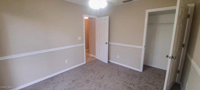 unfurnished bedroom with a closet and carpet