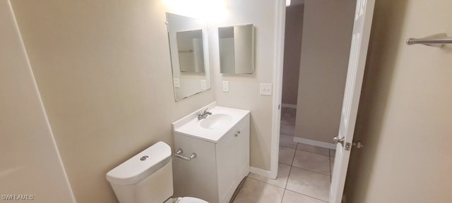 bathroom featuring tile patterned flooring, vanity, and toilet