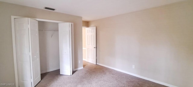 unfurnished bedroom with carpet flooring and a closet