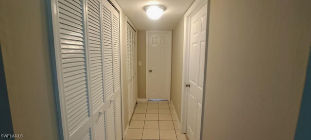 hall featuring light tile patterned floors