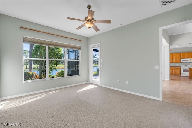 empty room featuring ceiling fan and light carpet