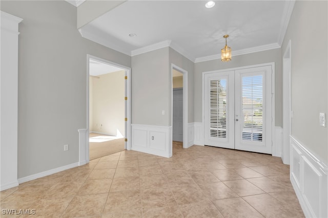 interior space with light tile patterned flooring, ornamental molding, and french doors