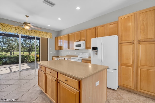 kitchen featuring white appliances, a kitchen island, ceiling fan, and light tile patterned flooring