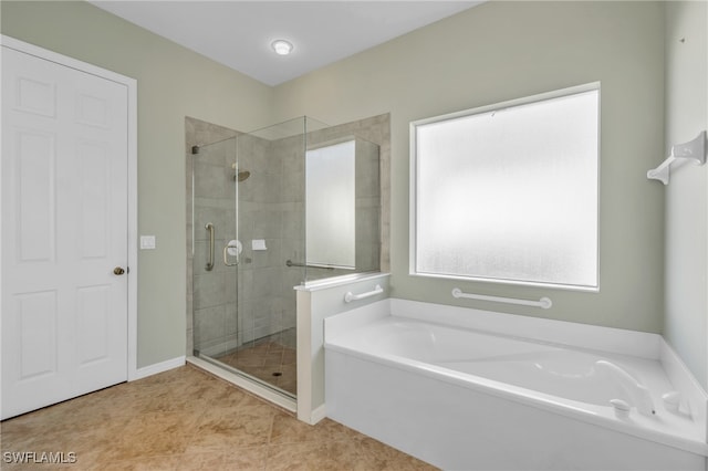 bathroom with separate shower and tub and tile patterned floors