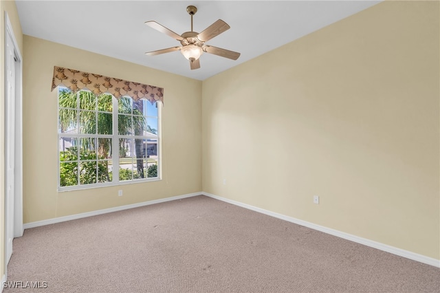 unfurnished room featuring ceiling fan and carpet floors