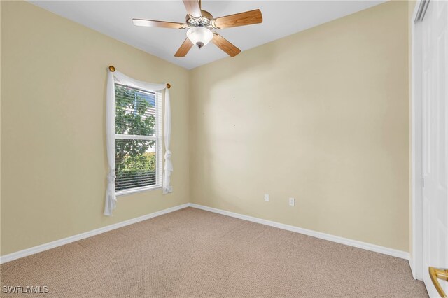 spare room featuring carpet and ceiling fan