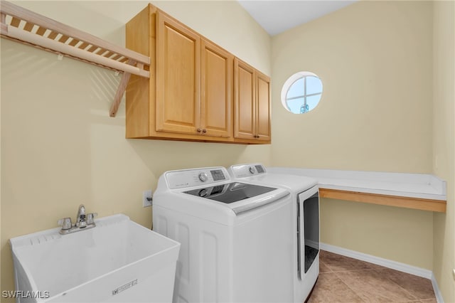 clothes washing area with sink, light tile patterned floors, cabinets, and independent washer and dryer