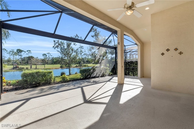 view of patio / terrace with a lanai, ceiling fan, and a water view