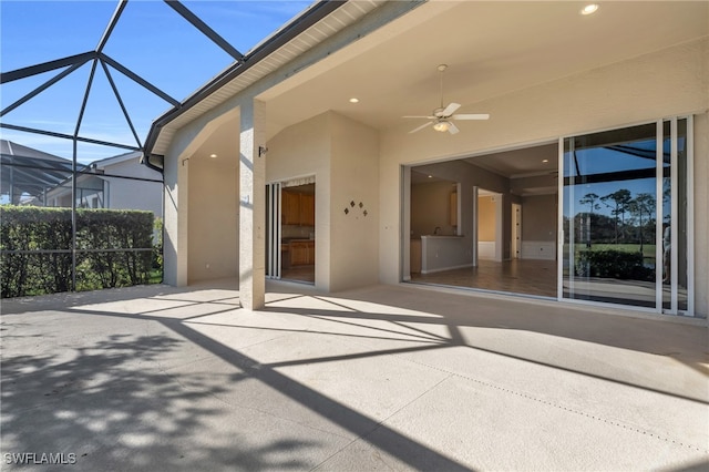 view of patio with ceiling fan and a lanai