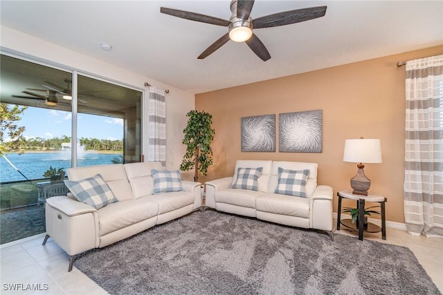 living area with tile patterned flooring and ceiling fan