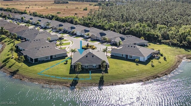 drone / aerial view featuring a residential view and a water view