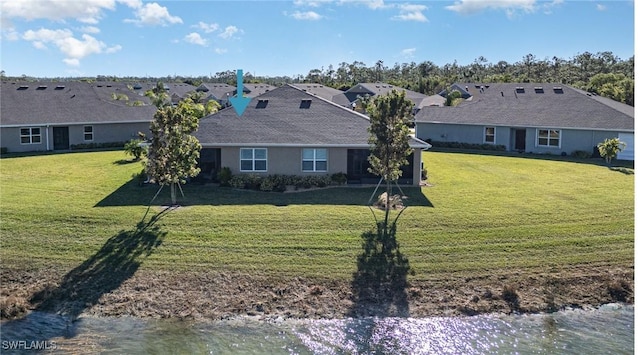 view of front of home with a front yard and stucco siding