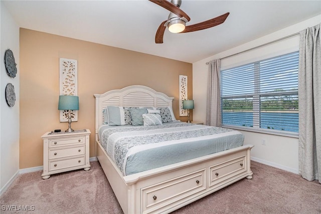 bedroom featuring baseboards, a ceiling fan, and light colored carpet