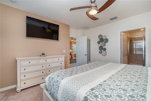 bedroom featuring baseboards, ceiling fan, visible vents, and light colored carpet