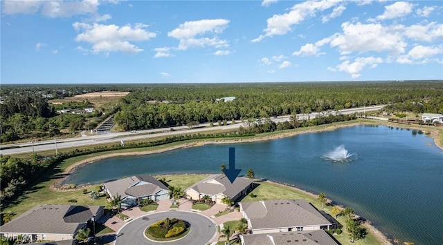 bird's eye view with a water view, a wooded view, and a residential view