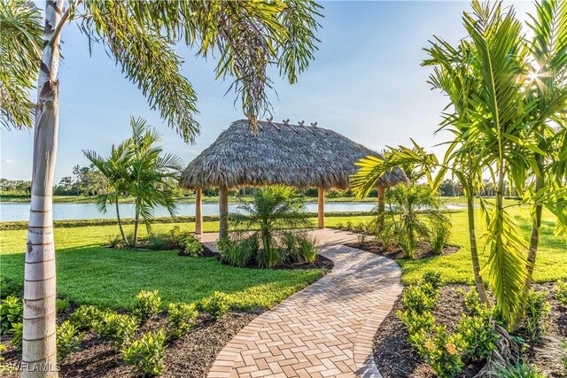 view of property's community featuring a water view, a gazebo, and a yard