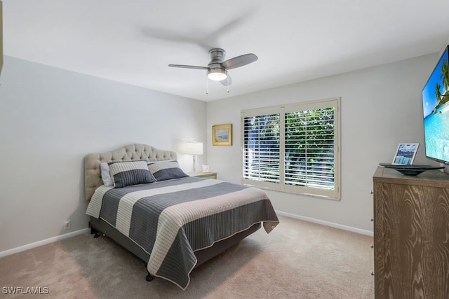 bedroom featuring light carpet and ceiling fan