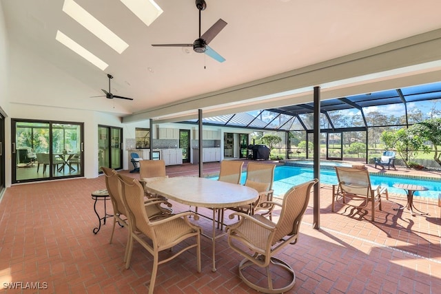 view of patio featuring glass enclosure and ceiling fan