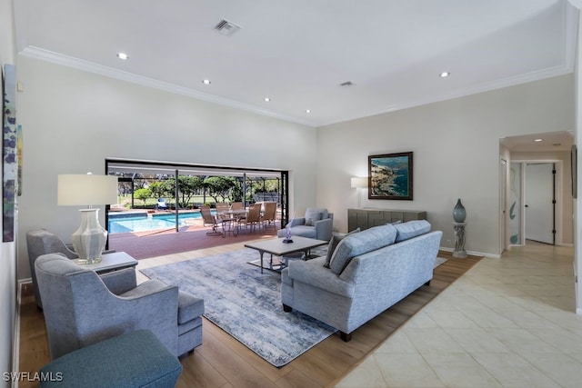 living room featuring light wood-type flooring and crown molding