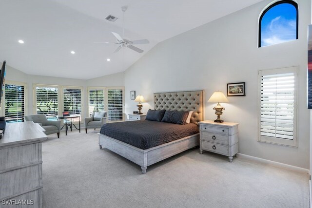 bedroom featuring ceiling fan, light colored carpet, high vaulted ceiling, and multiple windows