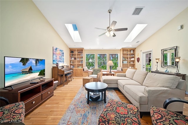 living room with ceiling fan, lofted ceiling, and light wood-type flooring