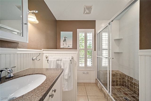 bathroom with tile patterned flooring, vanity, an enclosed shower, and lofted ceiling