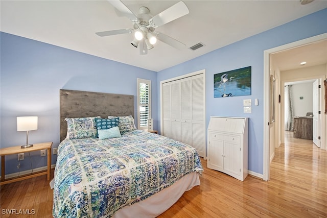 bedroom with light hardwood / wood-style flooring, a closet, and ceiling fan