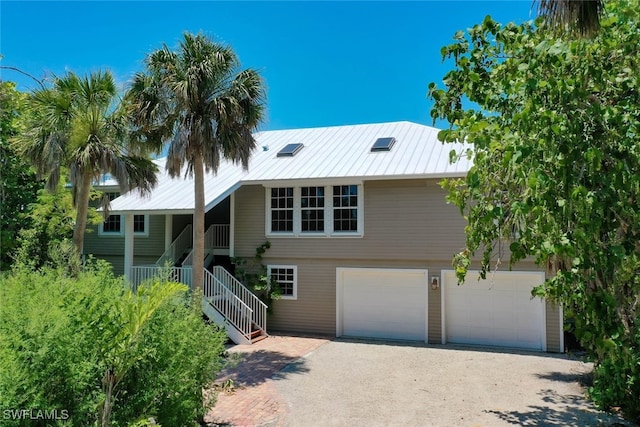 view of front facade with covered porch and a garage